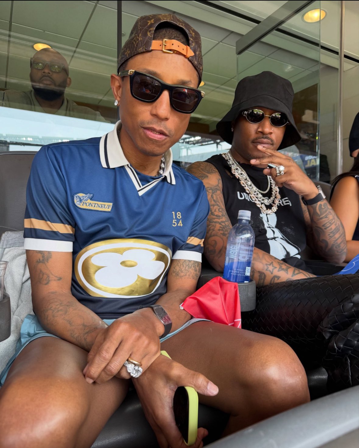 Pharrell and Future sitting next to each other at the finals